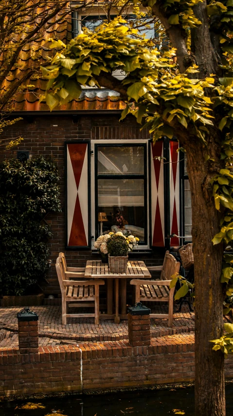 a table outside next to a tree near a building