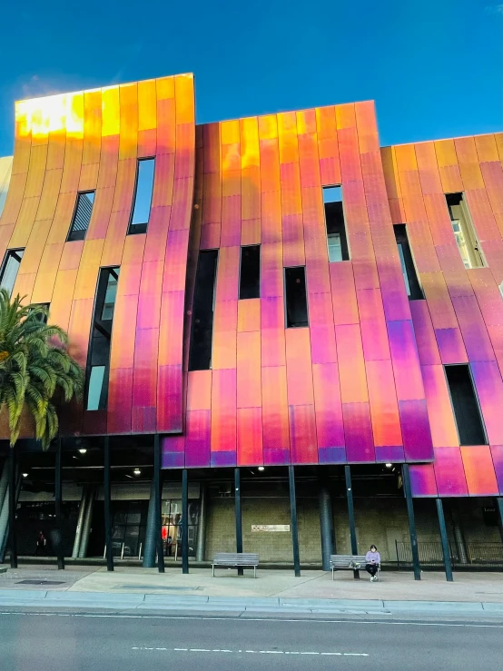 a building that has some pink and yellow shapes