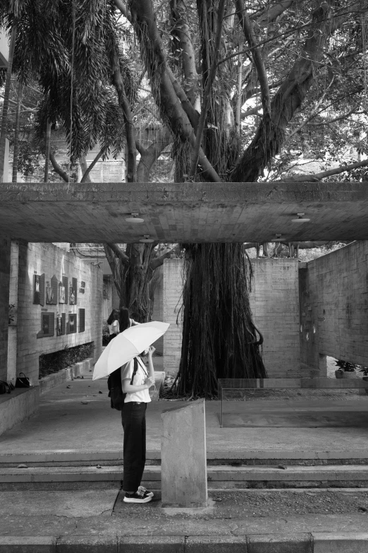 a person that is holding an umbrella in a black and white po