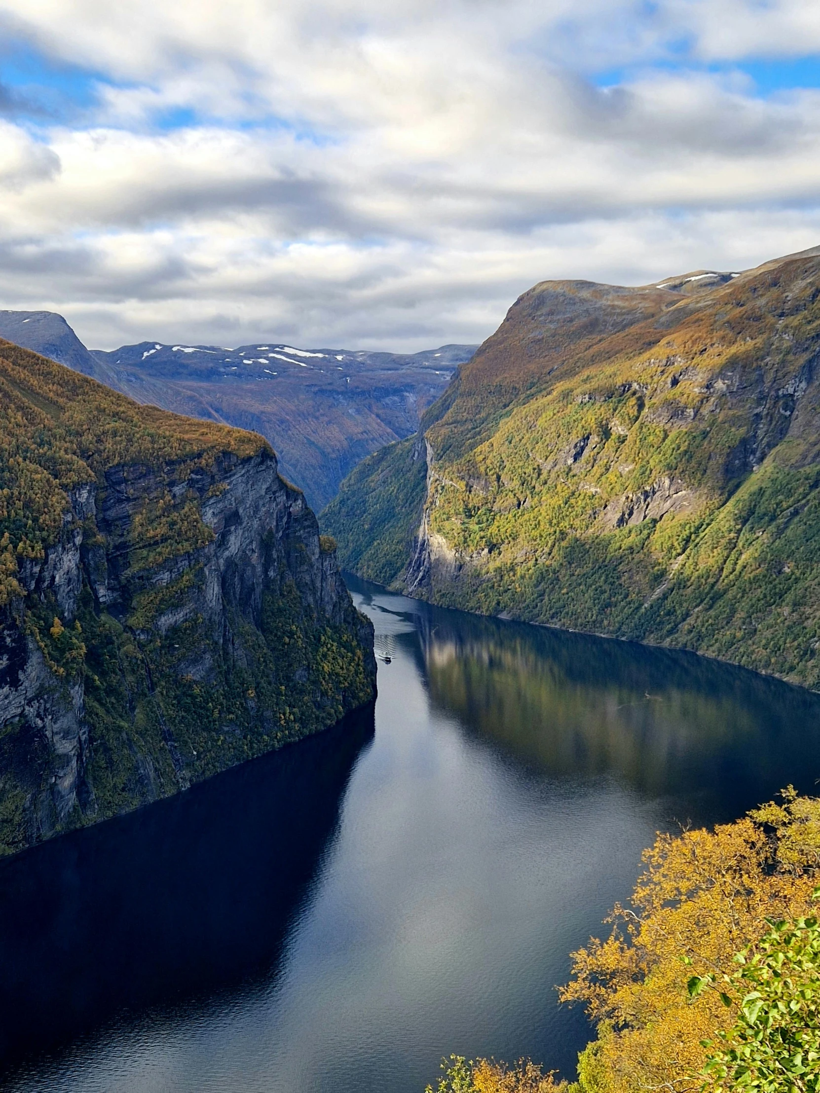 there is a lake near a mountain on the ocean