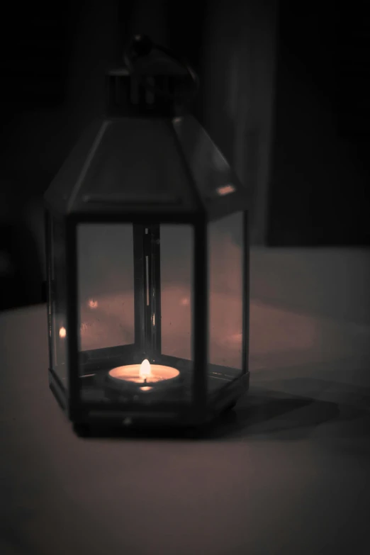 an empty lantern sits on a white surface