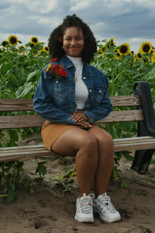 a woman sitting on a bench with flowers in her lap