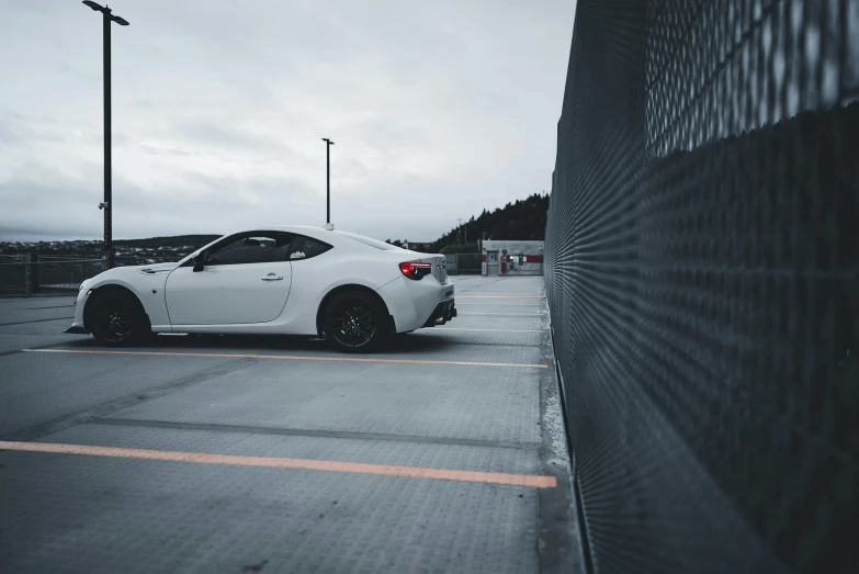 a car sitting in the middle of a parking lot