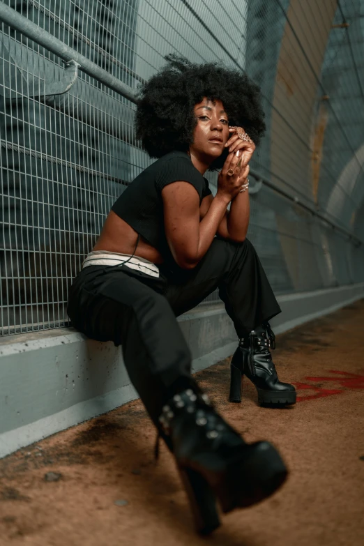 a woman wearing black clothes sitting down