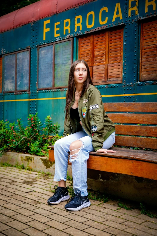 a girl is sitting on a bench with her feet crossed