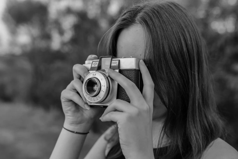 a woman is taking a picture in a black and white po