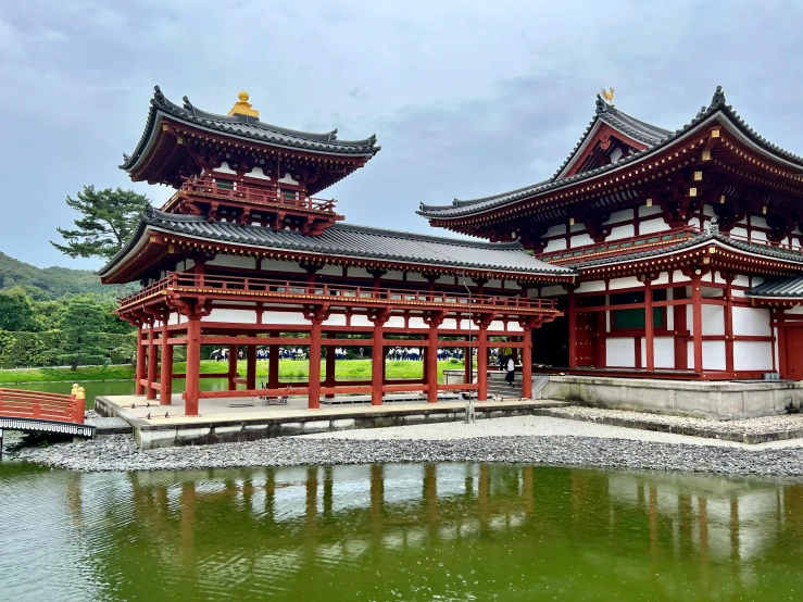 an old asian structure sits by the water