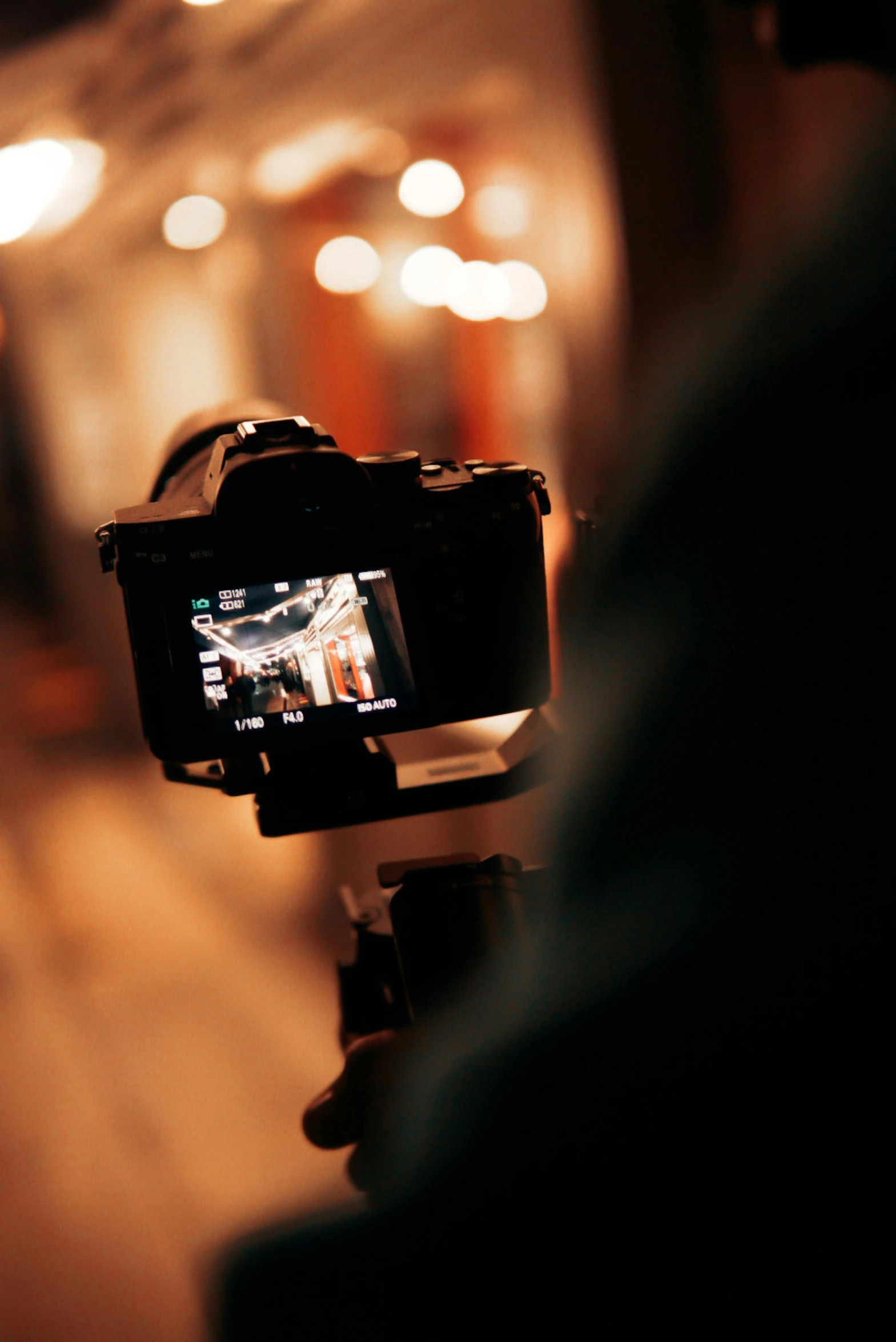 a camera on a tripod being used with the light coming in from the building