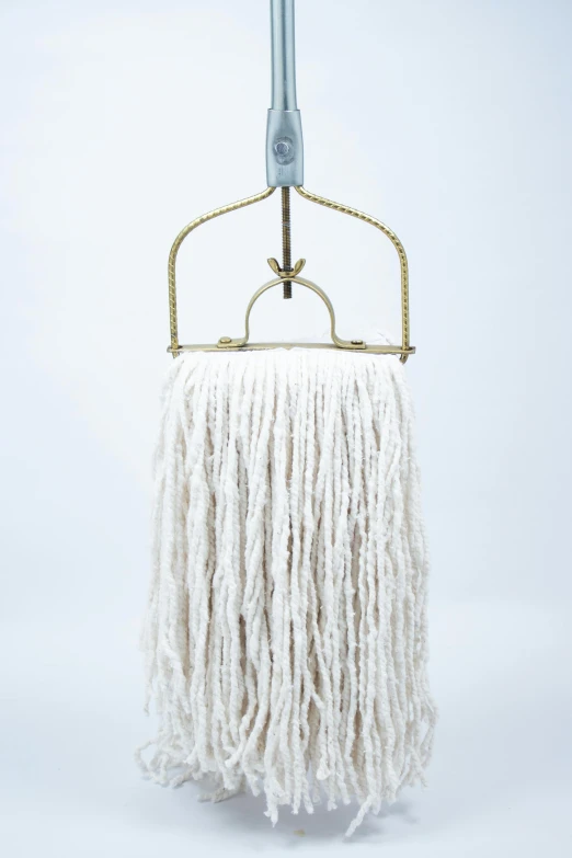 a mop sitting on top of a rack hanging on a wall