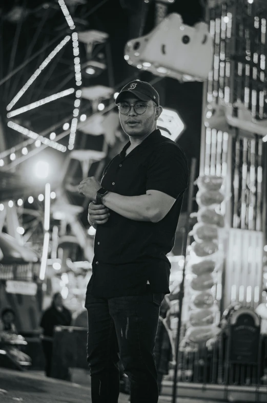 black and white image of a man standing outside at night