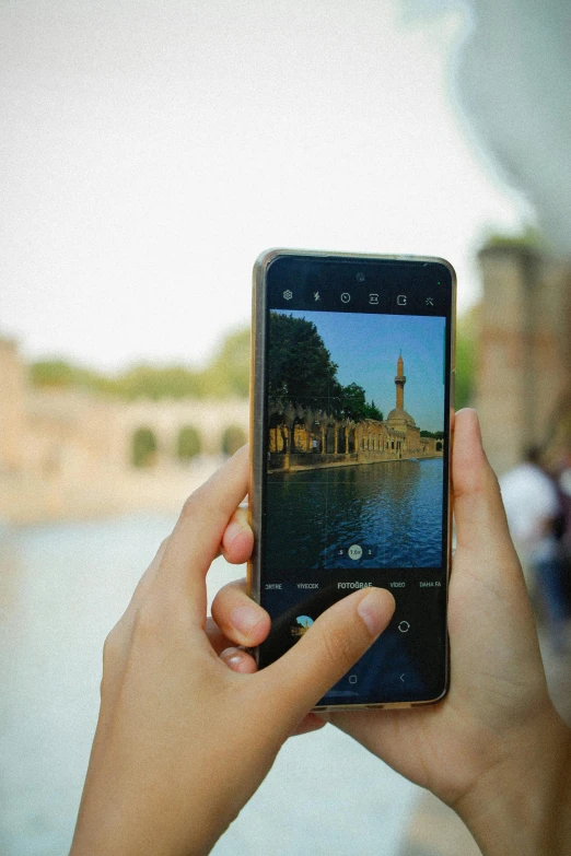 a woman holding a cell phone taking a picture