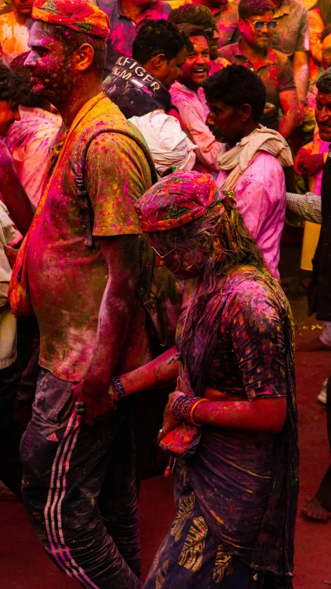 a crowd of people are covered with powder and color