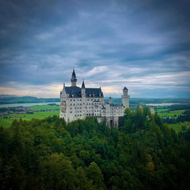 a castle sitting atop a lush green hillside