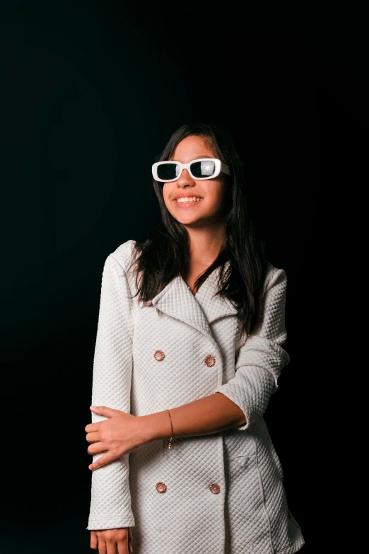 a young woman wearing glasses posing for the camera