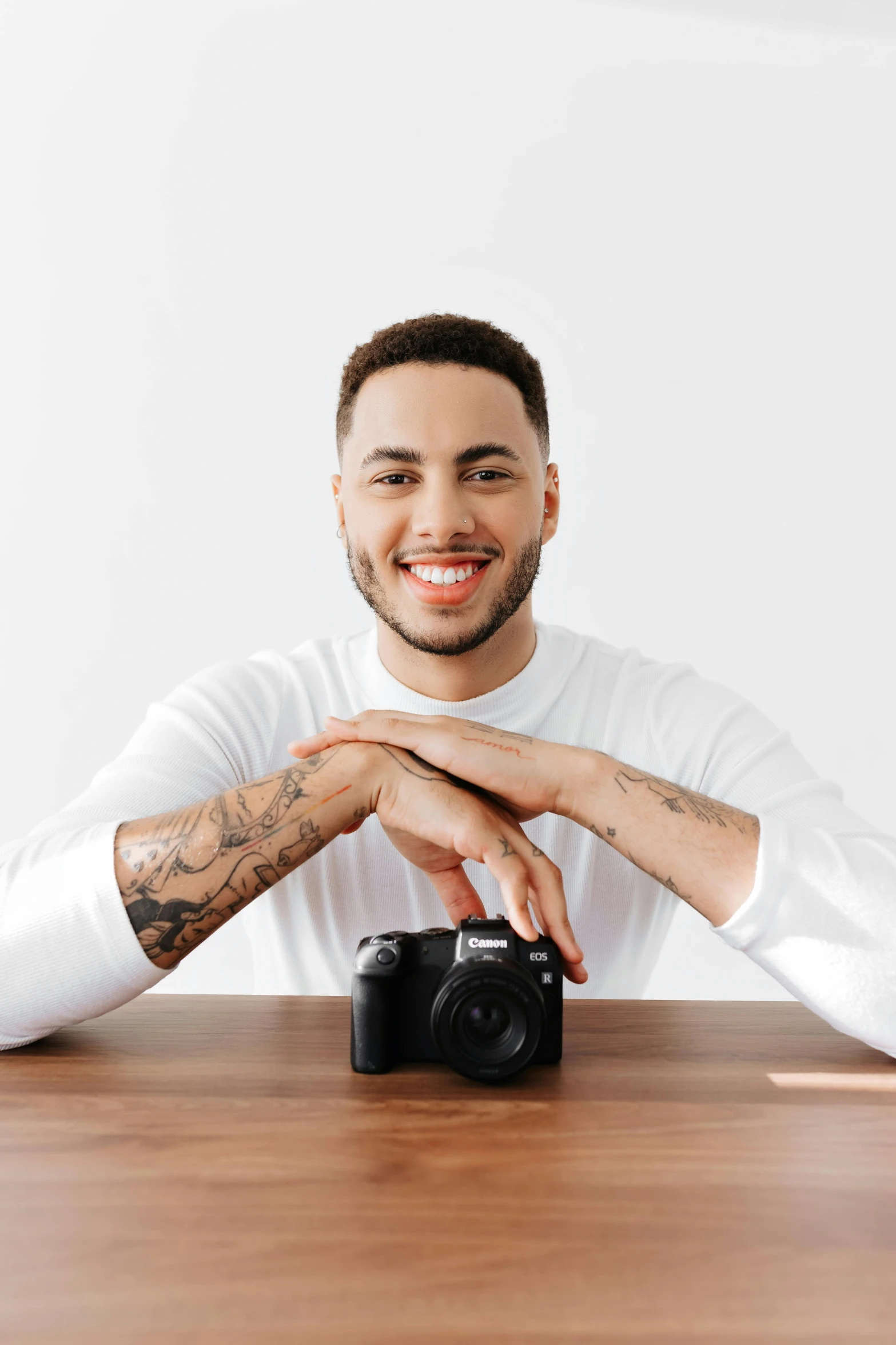 a man in white shirt holding onto a camera