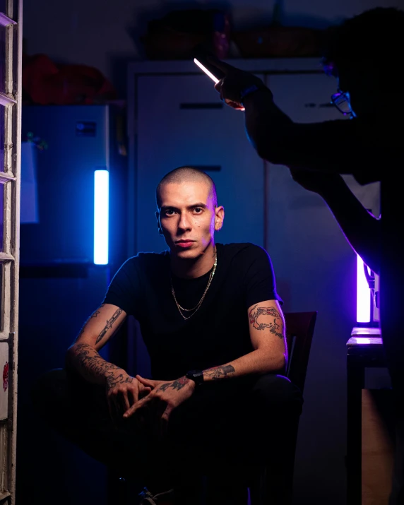 man in black shirt in a dark room