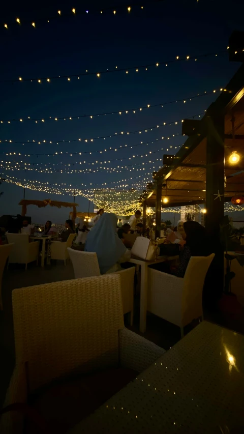 outdoor restaurant with an evening view of a city