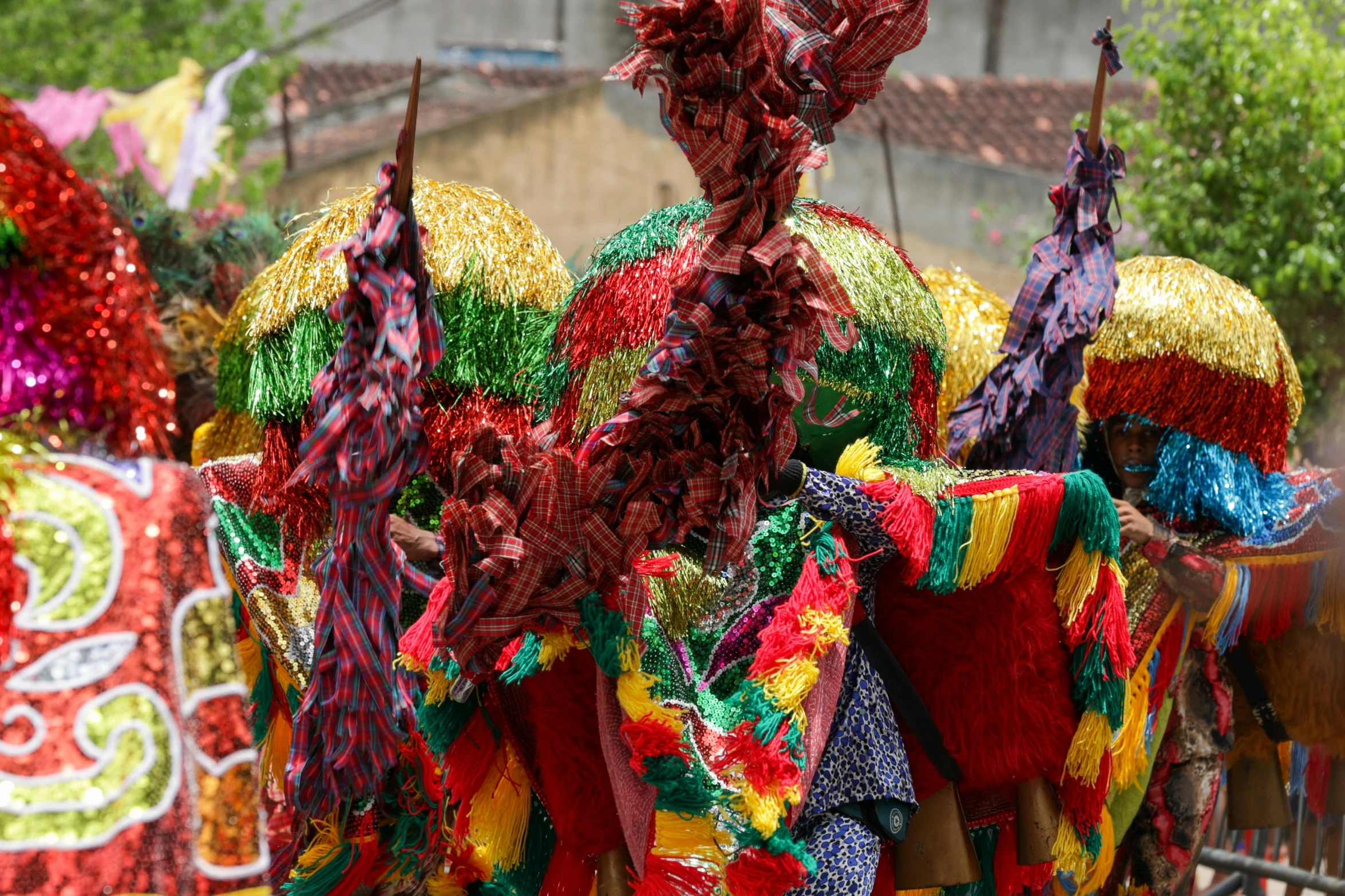 various colored costumes are lined up in rows