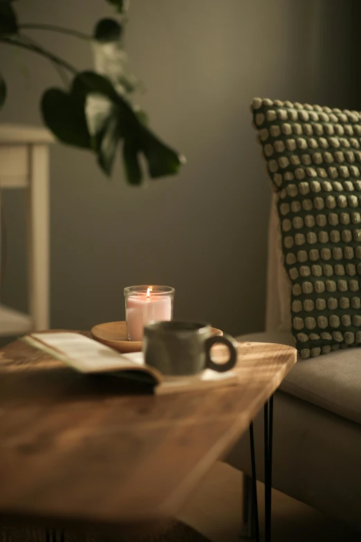 the view of the coffee table with two lit candles on it