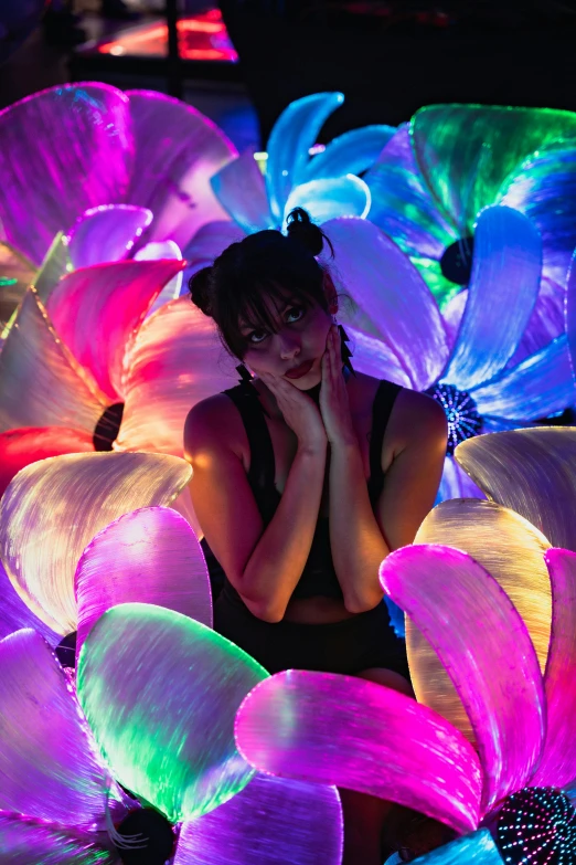 woman with head up in a bed of flowers