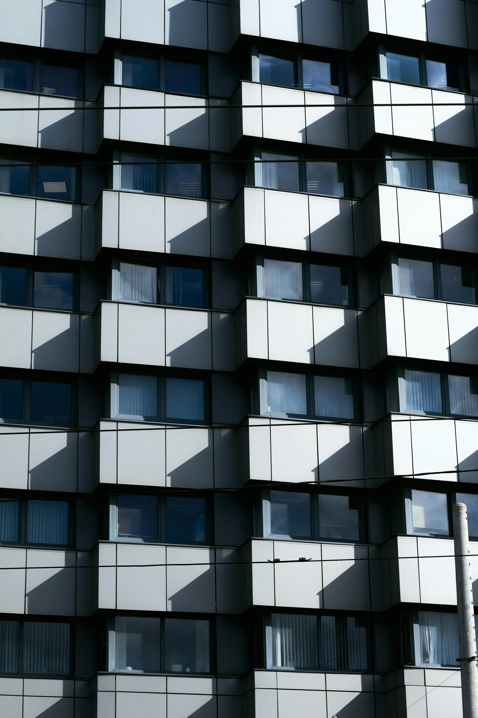 the facade of an abstract, modern building with balconies