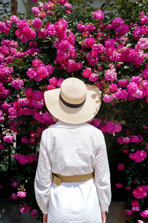 a person that is in front of some flowers