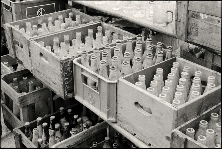 an industrial crate filled with bottles and wooden boxes