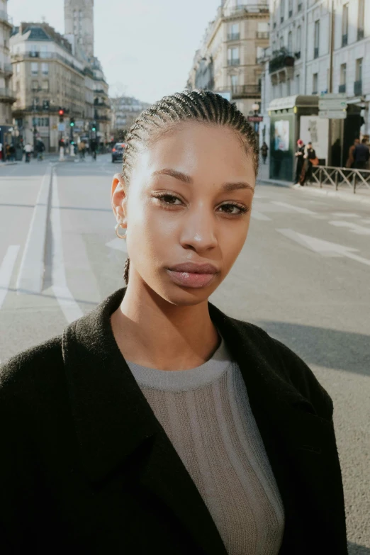 an image of a woman with ids and a black coat