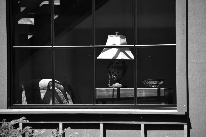 a lamp on the window ledge in a home