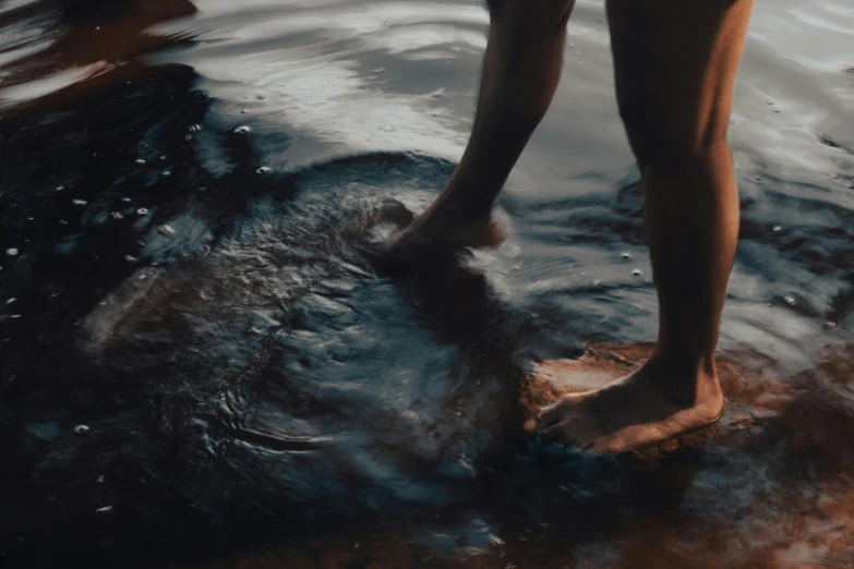 a woman is walking on top of a body of water