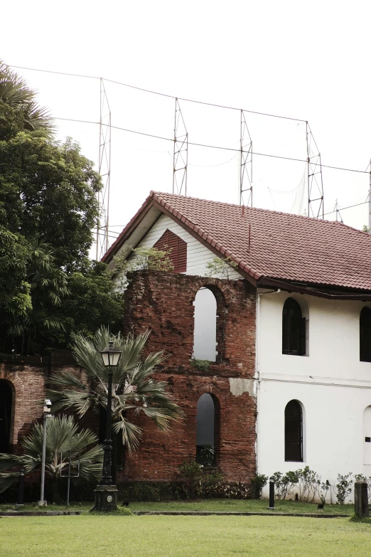 a brown and white building sitting in front of a bunch of trees