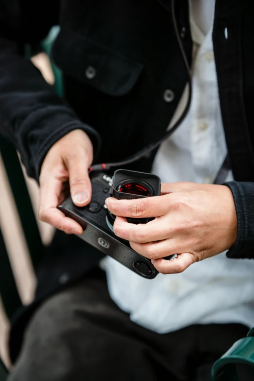 a person holding a cell phone with a black case and no hands