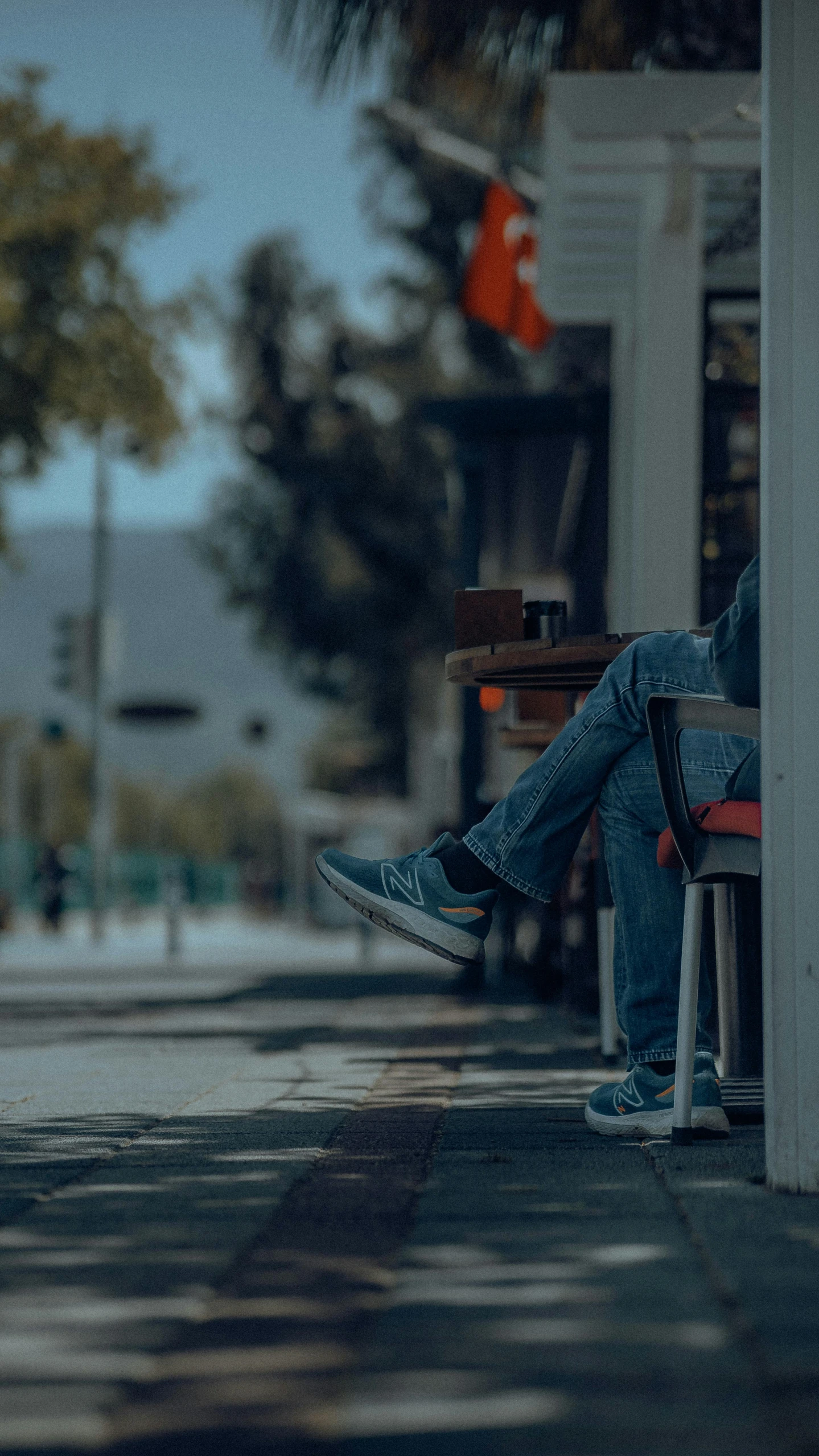 someone sitting on a bench on a street