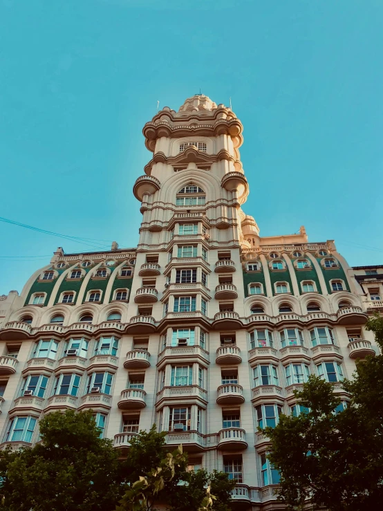 the view up to a large building with many balconies