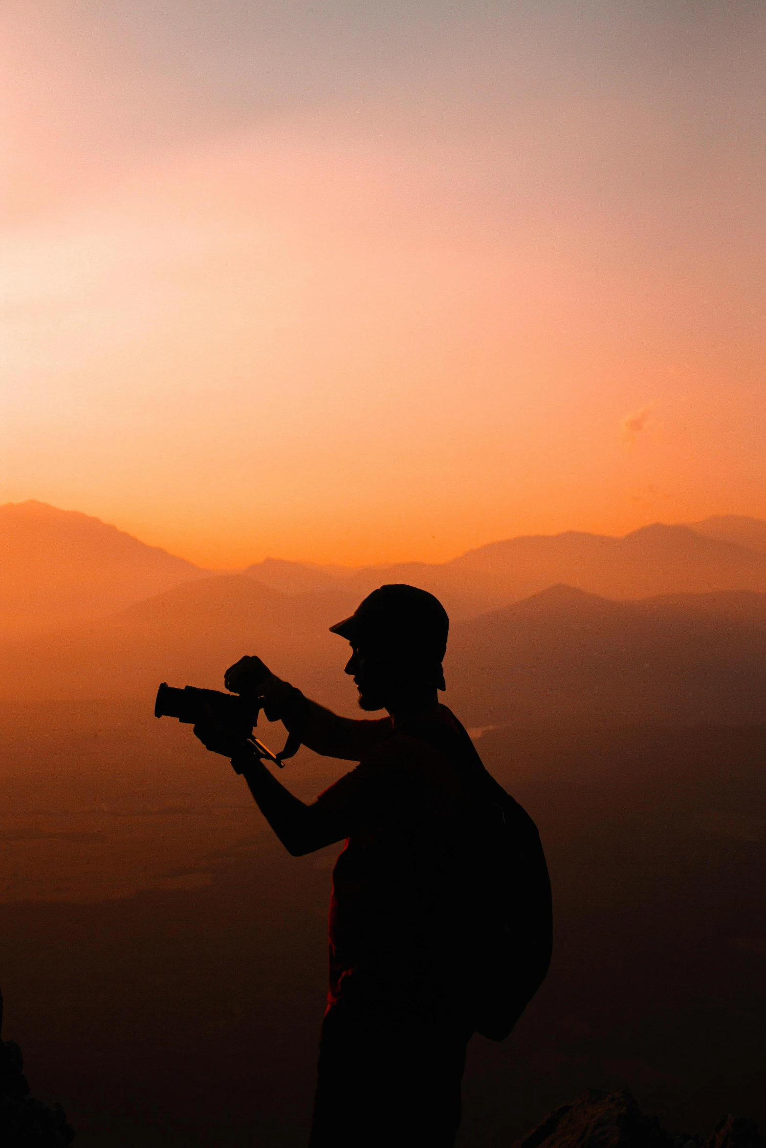 a person holds an air tool as the sun goes down