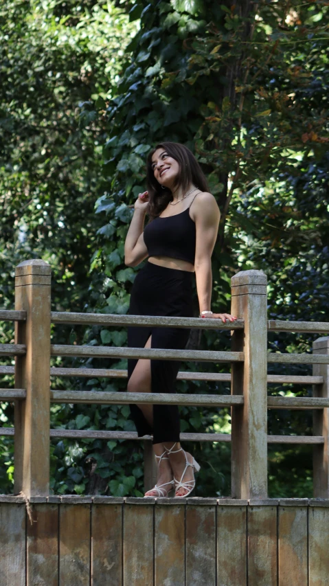 a woman standing on a deck wearing a skirt