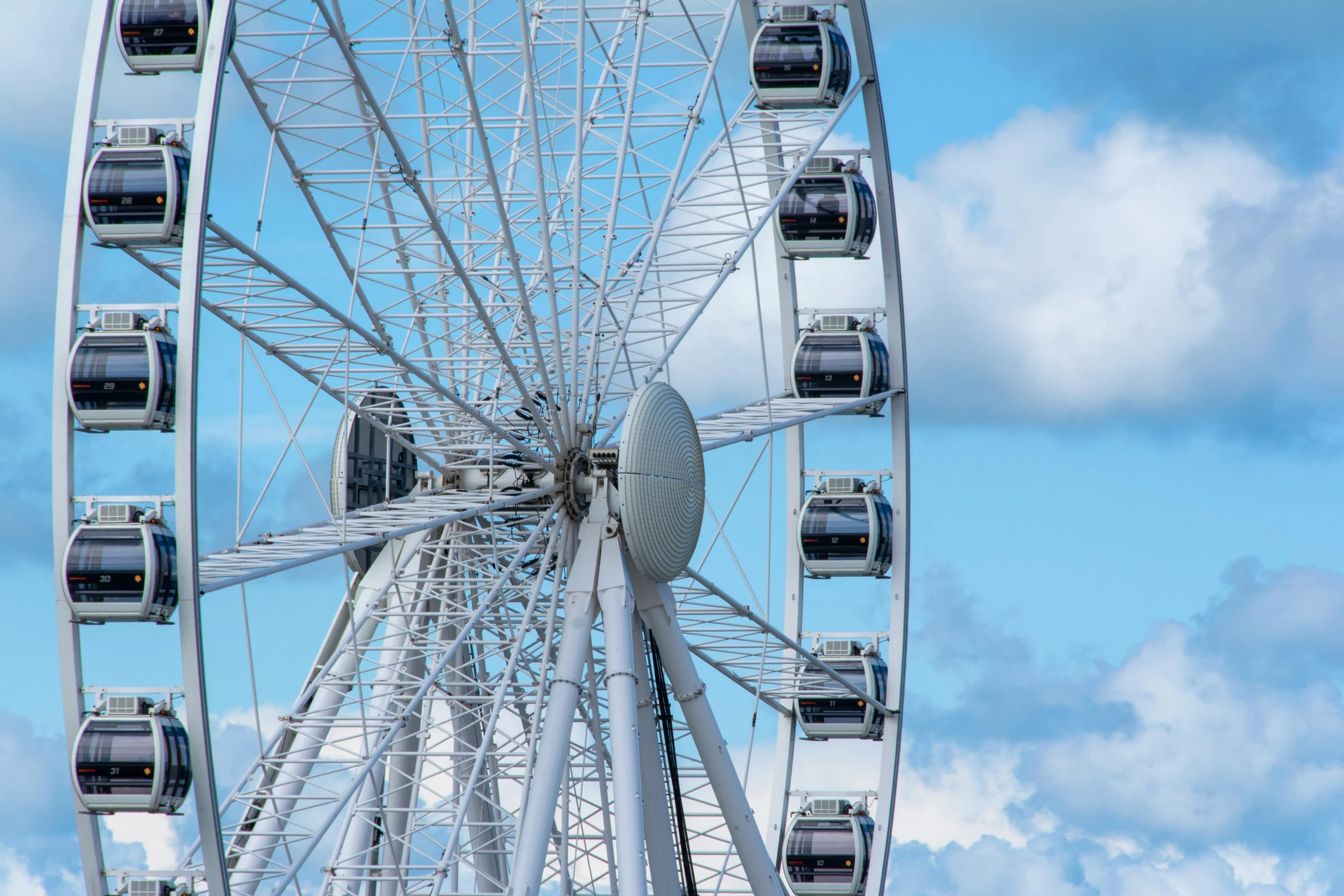 a ferris wheel and clouds in the sky