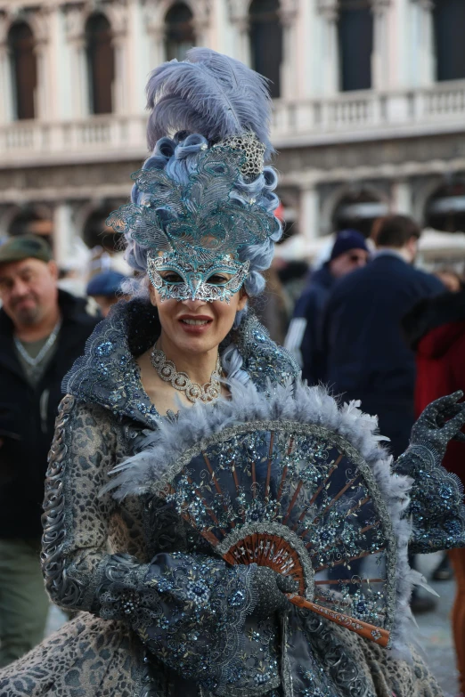 a women in costume walks down the street