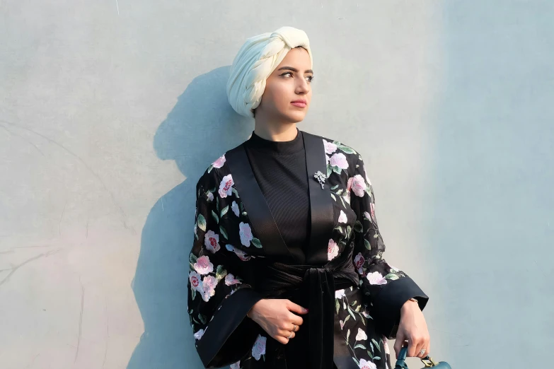 a woman wearing an embellished flower kimono over her dress