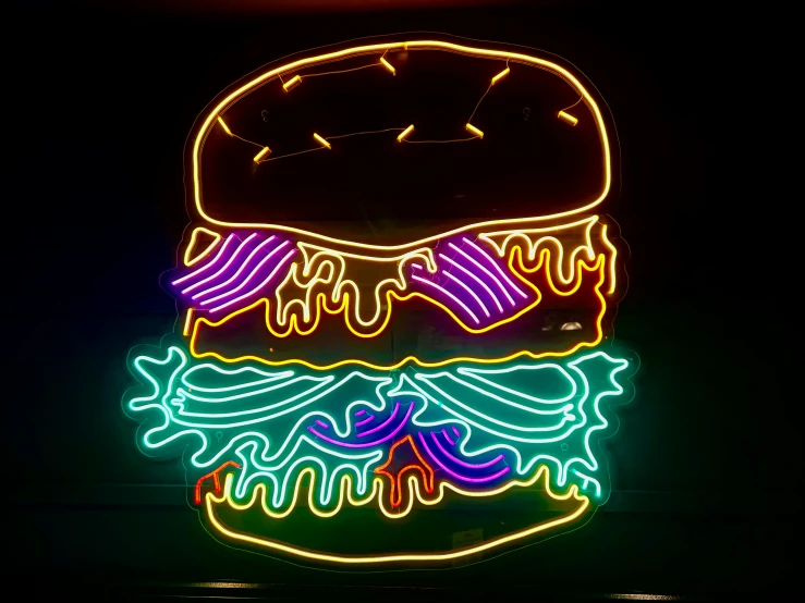 a big neon sandwich with different colored condiments