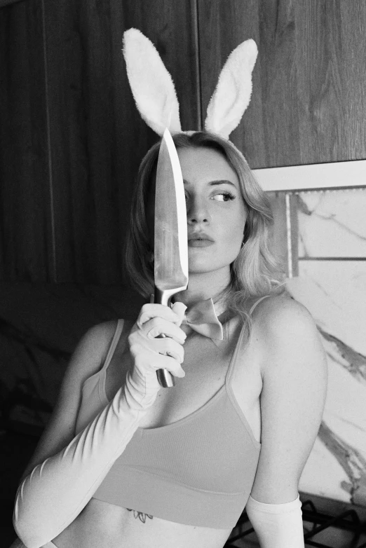 a woman dressed as a bunny with a knife
