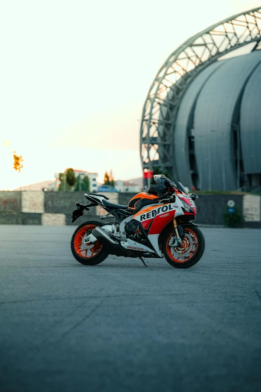 the motorcycle is parked near a building under an archway