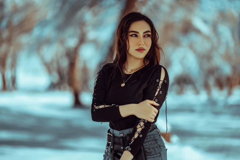 young woman in winter wonderland with a purse