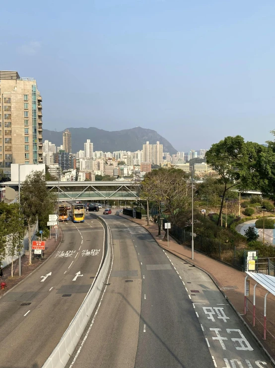 a street leading to an urban city with tall buildings