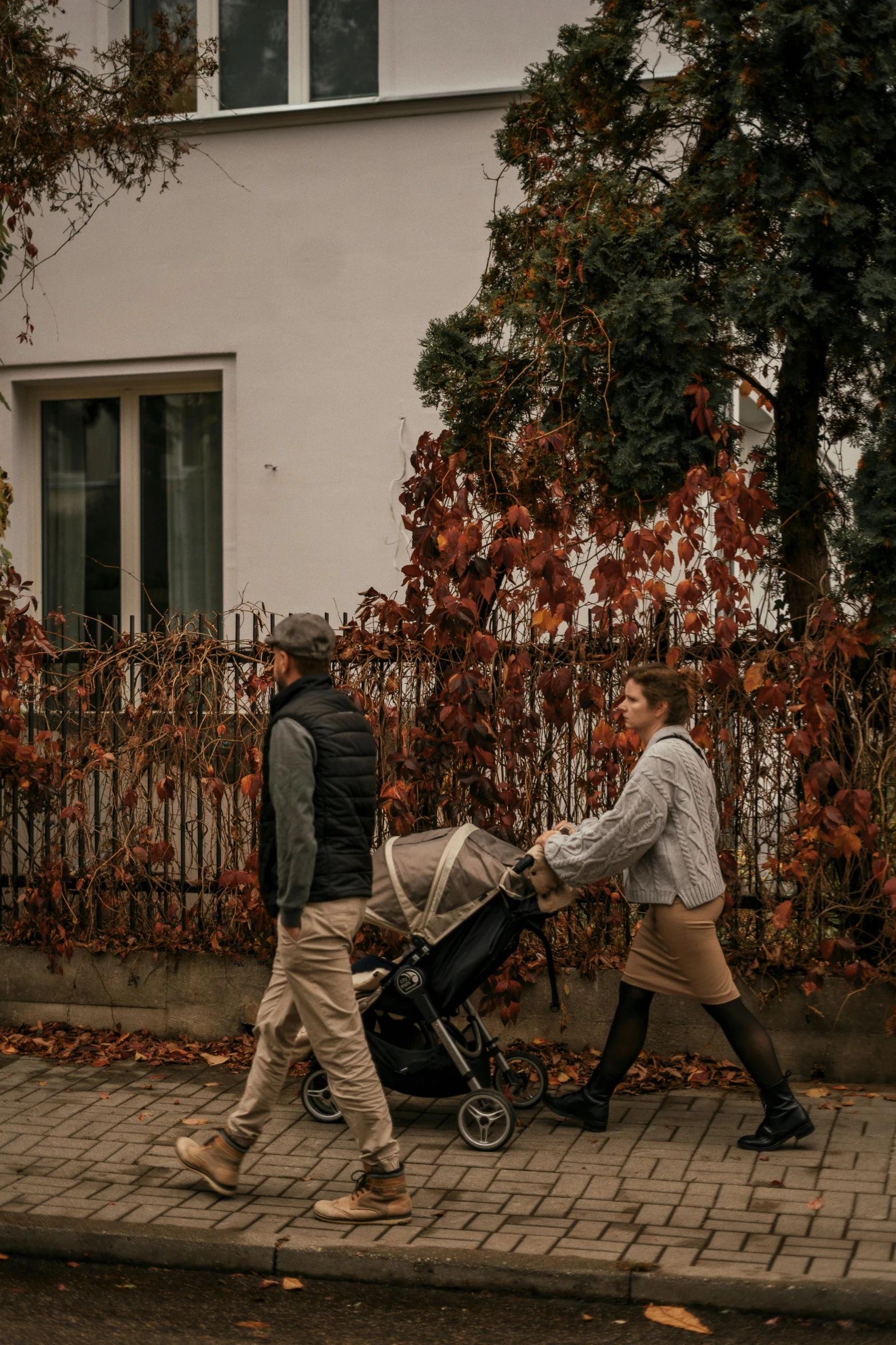 a man hing his baby carriage down the street