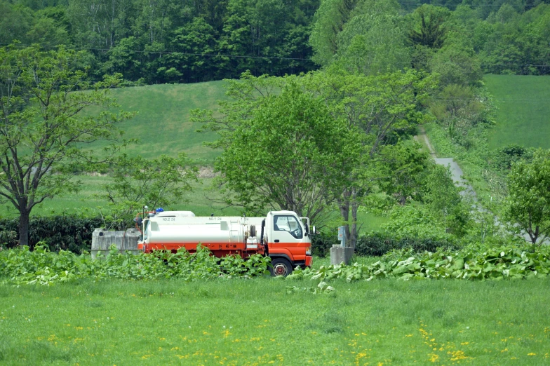 a big truck in a green field of grass