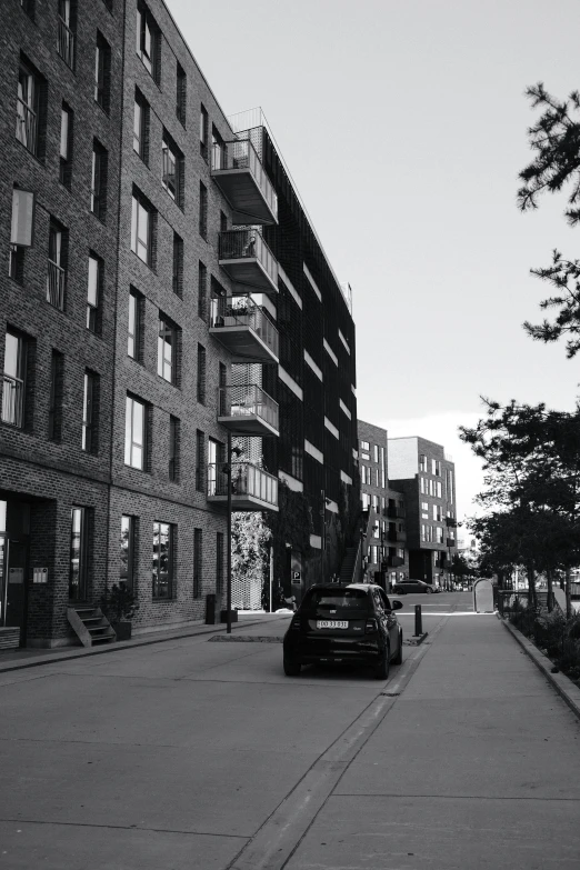 a black and white image of a city street with old buildings