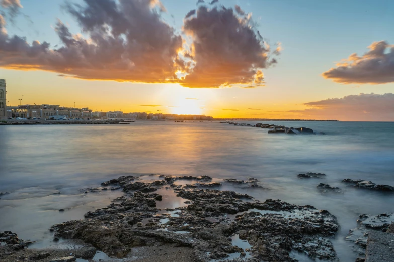 a beautiful sunset and city skyline along the ocean