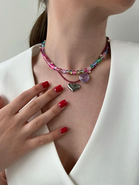 a woman wearing an elegant jewelry set with colorful stones