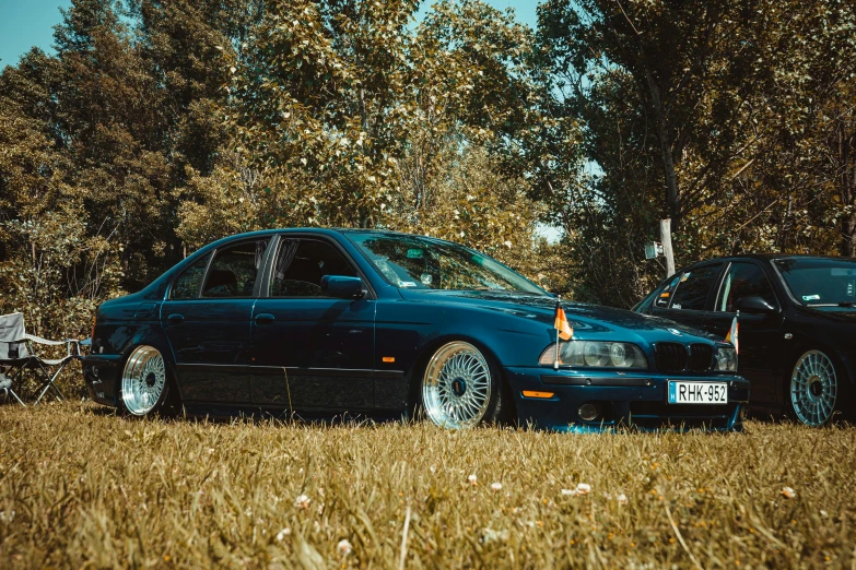 a very cute blue car parked in a field